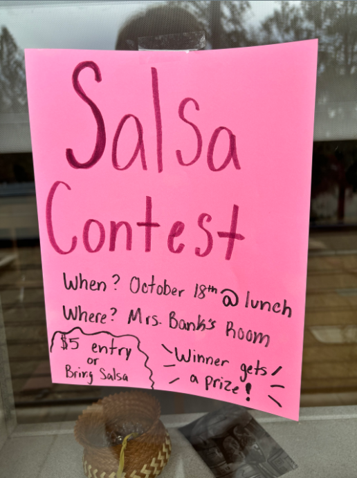 Colorful Salsa Contest poster on the art building with details about the event. 