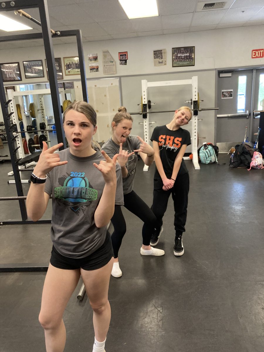 The Lady Bears condition in the weight room, waiting for the weather to improve. Freshman Deila Petersen, McKenzie Munsel, and Jaslyn McCulloch pose for a picture mid-workout.