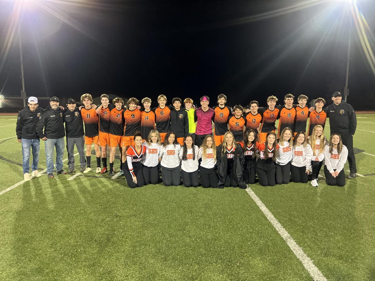 The Boys Soccer Team poses with their coaches and SHS cheerleaders after hosting their first ever state playoff game. 